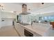 Open-concept kitchen with a large island, modern appliances, and seamless flow to the living area and water views at 404 S Shore Dr, Sarasota, FL 34234