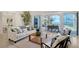 Elegant living room with stylish furniture, open to an outdoor dining area and stunning waterfront views at 404 S Shore Dr, Sarasota, FL 34234