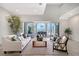 Bright living room featuring vaulted ceiling, seamless indoor-outdoor flow, and waterfront view at 404 S Shore Dr, Sarasota, FL 34234