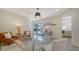Bright home office space with a glass desk and sliding glass doors to the outdoor patio at 404 S Shore Dr, Sarasota, FL 34234