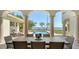 Expansive outdoor patio with comfortable dining set overlooking the sparkling pool and bay at 404 S Shore Dr, Sarasota, FL 34234
