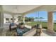 Covered patio with comfortable seating overlooking the lush lawn and tranquil waterfront at 404 S Shore Dr, Sarasota, FL 34234