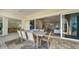 Open-concept patio with dining table, seating, and sliding glass doors to the home's interior at 404 S Shore Dr, Sarasota, FL 34234