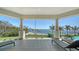 Inviting outdoor patio featuring lounge chairs and picturesque views of the lush lawn and serene water at 404 S Shore Dr, Sarasota, FL 34234