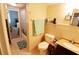 Well-lit bathroom with a tiled shower/tub combo, vanity, toilet, and doorway to another room at 4206 Heron Way # B305, Bradenton, FL 34205
