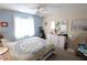 Cozy bedroom with plenty of natural light and a ceiling fan at 4206 Heron Way # B305, Bradenton, FL 34205