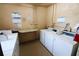 Convenient laundry room with multiple washing machines, folding table, and storage units at 4206 Heron Way # B305, Bradenton, FL 34205