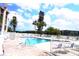 Inviting pool area with blue lounge chairs, a white fence, and views of the surrounding community at 4206 Heron Way # B305, Bradenton, FL 34205