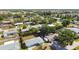 Residential neighborhood with well-maintained homes, mature trees, and lush landscaping viewed from above at 440 Redwood Rd, Venice, FL 34293
