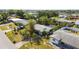 Aerial view showcasing a well-maintained home and surrounding landscaping in a suburban neighborhood at 440 Redwood Rd, Venice, FL 34293