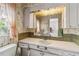 Vintage bathroom showcasing classic wallpaper, decorative cabinets, and natural light from the window at 440 Redwood Rd, Venice, FL 34293