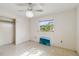 Clean, simple bedroom featuring polished floors, ample natural light, and a ceiling fan at 440 Redwood Rd, Venice, FL 34293