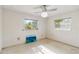 Bright bedroom with two windows, ceiling fan, and vintage flooring at 440 Redwood Rd, Venice, FL 34293
