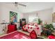 Well-lit bedroom includes stylish furnishings, a vibrant rug, and a window for natural light at 440 Redwood Rd, Venice, FL 34293