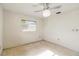 Basic bedroom layout with bright natural light, ceiling fan, and vintage flooring at 440 Redwood Rd, Venice, FL 34293