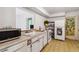Well-lit kitchen featuring standard appliances, laminate floors, and a convenient layout at 440 Redwood Rd, Venice, FL 34293