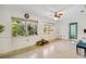 This simple living room features terrazzo flooring, large windows, and minimalist decor at 440 Redwood Rd, Venice, FL 34293