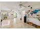An airy living room featuring large windows, terrazzo flooring, and a colorful world map at 440 Redwood Rd, Venice, FL 34293