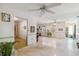 Spacious living room with white walls, terrazzo floors, and multiple ceiling fans at 440 Redwood Rd, Venice, FL 34293