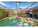 Clear-screened pool area surrounded by lush greenery, providing a serene and private outdoor space at 440 Redwood Rd, Venice, FL 34293
