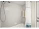 Bright bathroom featuring tiled walls, shower head, and neutral-colored decor at 4449 Greenfield Ave, Sarasota, FL 34233