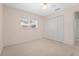 Spare bedroom features neutral walls and carpet, and a closet for storage at 4449 Greenfield Ave, Sarasota, FL 34233
