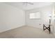 Spare bedroom with neutral walls and carpet features a window and ceiling fan at 4449 Greenfield Ave, Sarasota, FL 34233