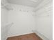 Walk-in closet with built-in white wire shelving for organized storage at 4449 Greenfield Ave, Sarasota, FL 34233