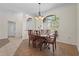 Classic dining room with traditional furnishings and natural light from large windows at 4449 Greenfield Ave, Sarasota, FL 34233