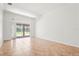 A bright, empty room with tile flooring and sliding doors to the pool area at 4449 Greenfield Ave, Sarasota, FL 34233