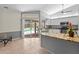 Bright kitchen with white cabinets, granite countertops, and view to screened pool at 4449 Greenfield Ave, Sarasota, FL 34233