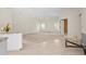 Open living space with light-colored carpet and high ceilings at 4449 Greenfield Ave, Sarasota, FL 34233