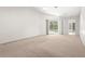 Bright, carpeted main bedroom offers access to the pool and a glimpse of the yard at 4449 Greenfield Ave, Sarasota, FL 34233