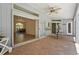 Covered patio with brick flooring, ceiling fan, and view to indoor dining area at 4449 Greenfield Ave, Sarasota, FL 34233