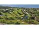 An aerial view of a golf course community with ponds, mature trees, and well manicured green spaces at 5715 Inspiration Ter, Bradenton, FL 34210