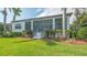 A screened-in back porch provides outdoor living space and view of the landscaped backyard at 5715 Inspiration Ter, Bradenton, FL 34210