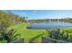 Serene backyard with a view of the lake, lush landscaping, and beautiful water features at 5715 Inspiration Ter, Bradenton, FL 34210