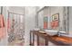 Elegant bathroom featuring dual vessel sinks, floral shower curtain, and a decorative mirror at 5715 Inspiration Ter, Bradenton, FL 34210