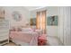 Charming bedroom with patterned bedding, artistic decor, and plenty of natural light at 5715 Inspiration Ter, Bradenton, FL 34210
