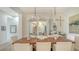 Elegant dining room with a modern light fixture and stylish decor for entertaining guests at 5715 Inspiration Ter, Bradenton, FL 34210