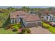 Beautiful Mediterranean home with a tile roof, two-car garage, and manicured landscaping at 5715 Inspiration Ter, Bradenton, FL 34210
