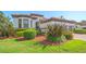 The beautiful Mediterranean home has an attached garage and professionally landscaped front yard at 5715 Inspiration Ter, Bradenton, FL 34210