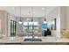Kitchen with marble countertops open to the living space featuring a water view from the large windows at 5715 Inspiration Ter, Bradenton, FL 34210