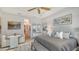 Spacious and well-lit main bedroom featuring neutral tones, art, and a comfortable sitting area with a bench at 5715 Inspiration Ter, Bradenton, FL 34210