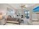 Bright main bedroom features a tray ceiling, backyard view, and a private door to the outdoor lanai at 5715 Inspiration Ter, Bradenton, FL 34210