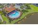 Aerial view of a community pool, with lounge chairs and a covered seating area at 5715 Inspiration Ter, Bradenton, FL 34210