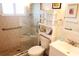 Well-lit bathroom showcasing a glass-enclosed shower, decorative tile work, and a vanity for extra storage at 5888 17Th W St # C23, Bradenton, FL 34207