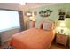 Cozy bedroom featuring a comfortable bed, tropical decor, and a bright window for natural light at 5888 17Th W St # C23, Bradenton, FL 34207