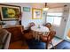 Dining room features a floral tablecloth and rattan chairs at 5888 17Th W St # C23, Bradenton, FL 34207