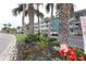 Condo complex view shows landscaping with flower beds in front of the building at 5888 17Th W St # C23, Bradenton, FL 34207